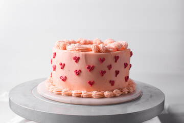 Pink buttercream cake on a cake plate, Cake covered in buttercream hearts