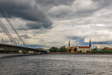Riga city landscape. A cable-stayed bridge over the Daugava River is visible, and on the opposite...