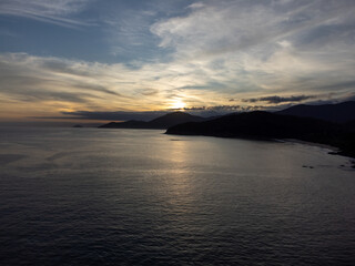sunset behind the mountains on the beach