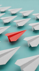 Red paper airplane stands out among white ones on teal background, symbolizing leadership, individuality, and standing out from the crowd