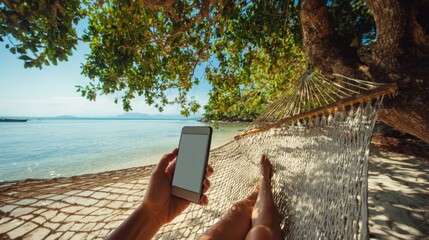 The hammock relaxing by the beach with a smartphone in hand.