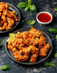 Korean fried chicken with spicy sauce and sesame seeds