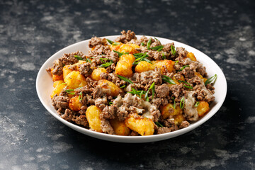 Loaded Tater tots Potatoes with beef and cheese. Fast food.