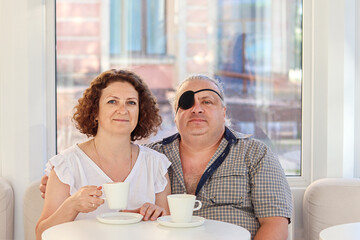 Middle-aged couple enjoying coffee together in a cozy cafe setting