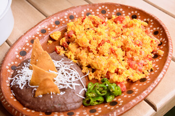 Scrambled eggs with ham and beans, traditional mexican breakfast