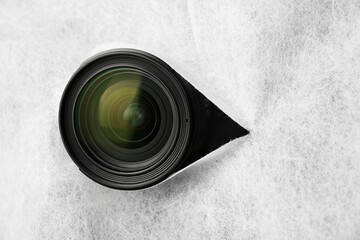 Hidden camera lens through torn hole in white fabric