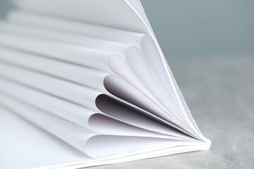 One open magazine on grey table, closeup