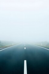 Fototapeta premium Navigating through dense fog on the road: a journey into the unknown landscape view