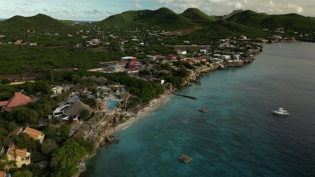 Drone sweep over Playa Kalki showing reef entry, swimmers, and lush coastal cliffs.
Use: Great for scuba diving intros, resort marketing, or tourism B-roll.
