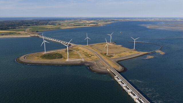 Wind turbines at Delta Works, Neeltje Jans, flood barrier in Zeeland, The Netherlands. Dutch infrastructure. Aerial video. Clean energy. Wind energy, renewable energy.