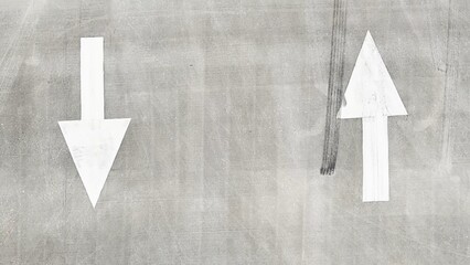 Two arrows on the asphalt of the road