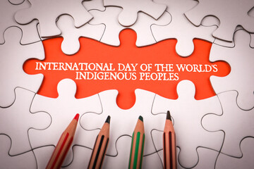 International Day of the World's Indigenous Peoples 9 August. White puzzle pieces and colored...