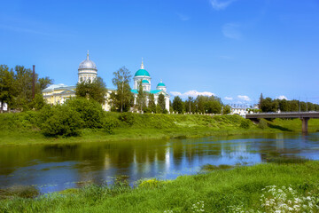 Summer landscape of the city of Torzhok. A view of the domes of churches and a pedestrian bridge.
