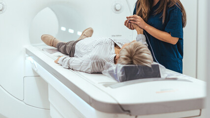Medical Technician Assists Patient During MRI Scan Procedure in a Hospital