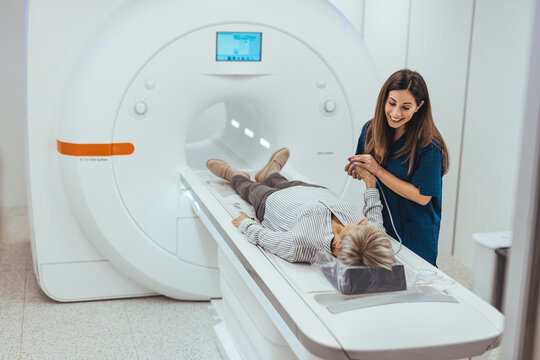 Patient Receiving an MRI Scan with Technician Offering Reassurance and Support