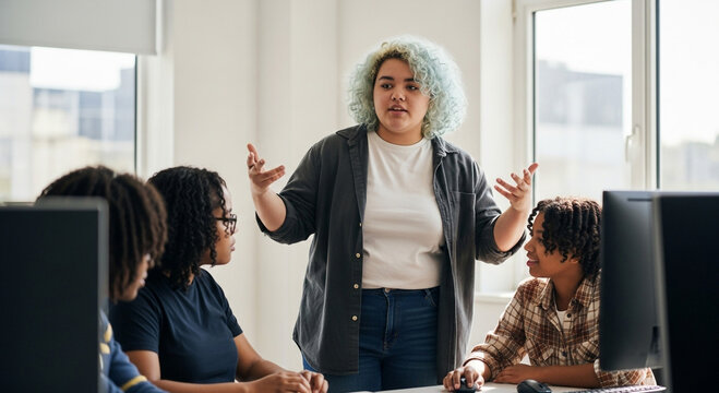 Non-binary teen teaching coding to diverse group in computer lab - Powered by Adobe