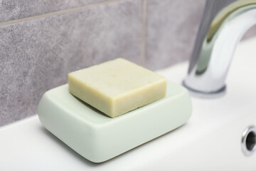 Soap bar on sink in bathroom, closeup