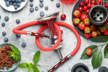Hookah and fresh fruits on grey table, flat lay