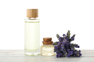 Natural essential oil and lavender flowers on wooden table against white background