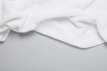 White terry towel on light grey background, top view. Space for text