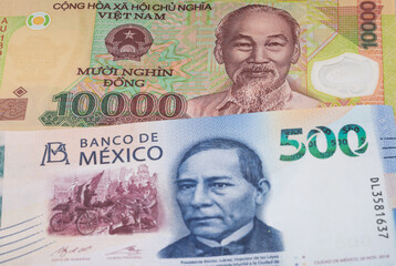 10000 Vietnamese dong and 500 Mexican peso banknotes. International trade concept
