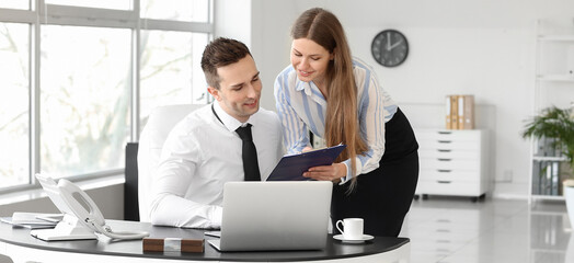 Boss and his beautiful secretary working in office