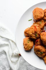 Overhead view of Akara on a white plate, top view of nigerian akara fried beans cake on a plate