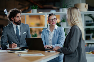 Business team discussing strategy during meeting in modern office
