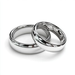 Two wedding rings are shown side by side. The rings are silver and have a shiny, reflective surface. Concept of elegance and love, as the rings are often worn by couples during their wedding ceremony