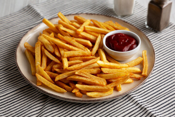 Homemade Golden French Fries with Ketchup, side view.