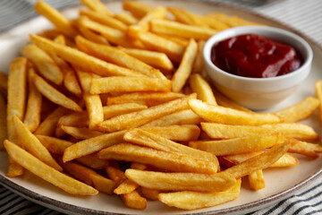 Homemade Golden French Fries with Ketchup, side view. Close-up.