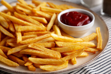 Homemade Golden French Fries with Ketchup, side view. Close-up.