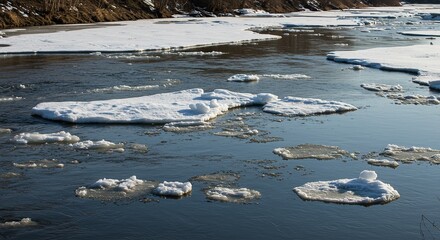River with ice floes floating on the water surface on a sunny day.