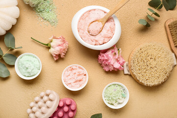 Beautiful spa composition with different body scrubs and bath supplies on color background