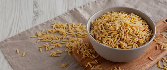 Organic Dried Orzo Pasta in a Bowl, side view.