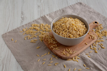 Organic Dried Orzo Pasta in a Bowl, side view. Copy space.