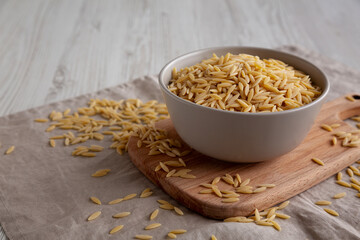 Organic Dried Orzo Pasta in a Bowl, side view. Copy space.