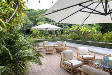 Outdoor patio lounge with bamboo furniture and tropical greenery