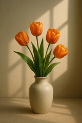 Vibrant orange tulips in vase with soft natural light and shadows