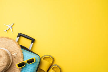 Travel essentials including a suitcase, straw hat, sunglasses, and sandals on a yellow backdrop,...