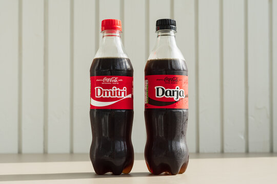 TALLINN, ESTONIA - JULY 7, 2025: A bottle of Coca-Cola Original Taste with the name 'Dmitri' and a Coca-Cola Zero Sugar with the name 'Darja'.