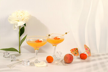 Iced punch with apricots for party,Modern still life with summer alcoholic cocktail and peonies on...