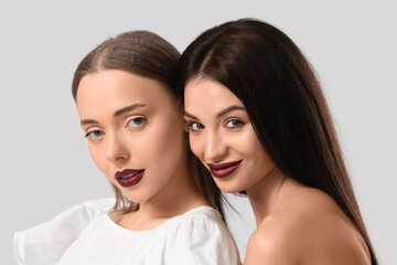 Two different young women posing on white background. Yin Yang concept