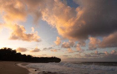 Beautiful sunrise and vibrant clouds above Shipwreck beach on Kauai
