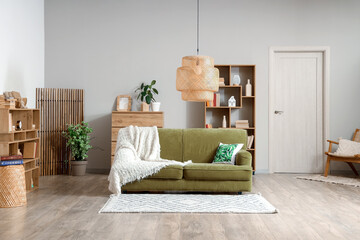 Comfortable sofa and bookcases in interior of living room