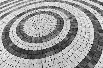 Abstract close-up view of a circular paving pattern, background texture