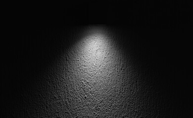 A focused spotlight highlighting the texture of a rough wall surface