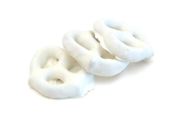 Colorful chocolate covered pretzels on white background