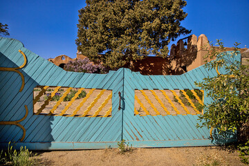 Blue wooden drive way gate, southwestern architecture, diagonal lines, iron accents. New Mexico.