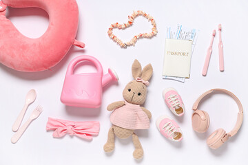 Composition with passport, toy bunny and children's accessories on white background, closeup